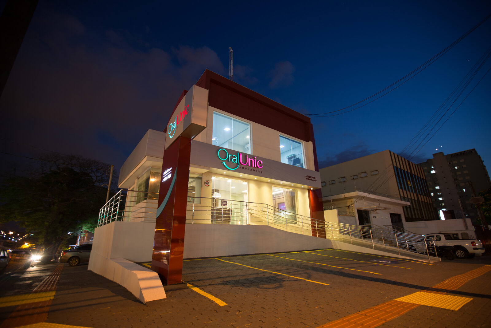 Fachada da Oral Unic Campo Grande na Av. Afonso Pena ao anoitecer